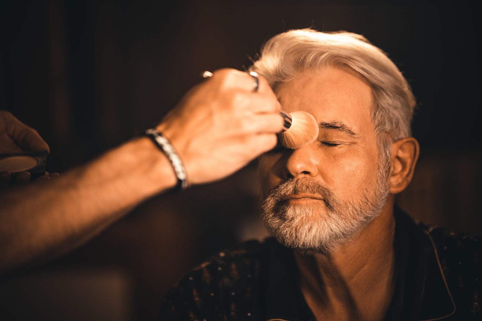 Makeup being applied during a production.