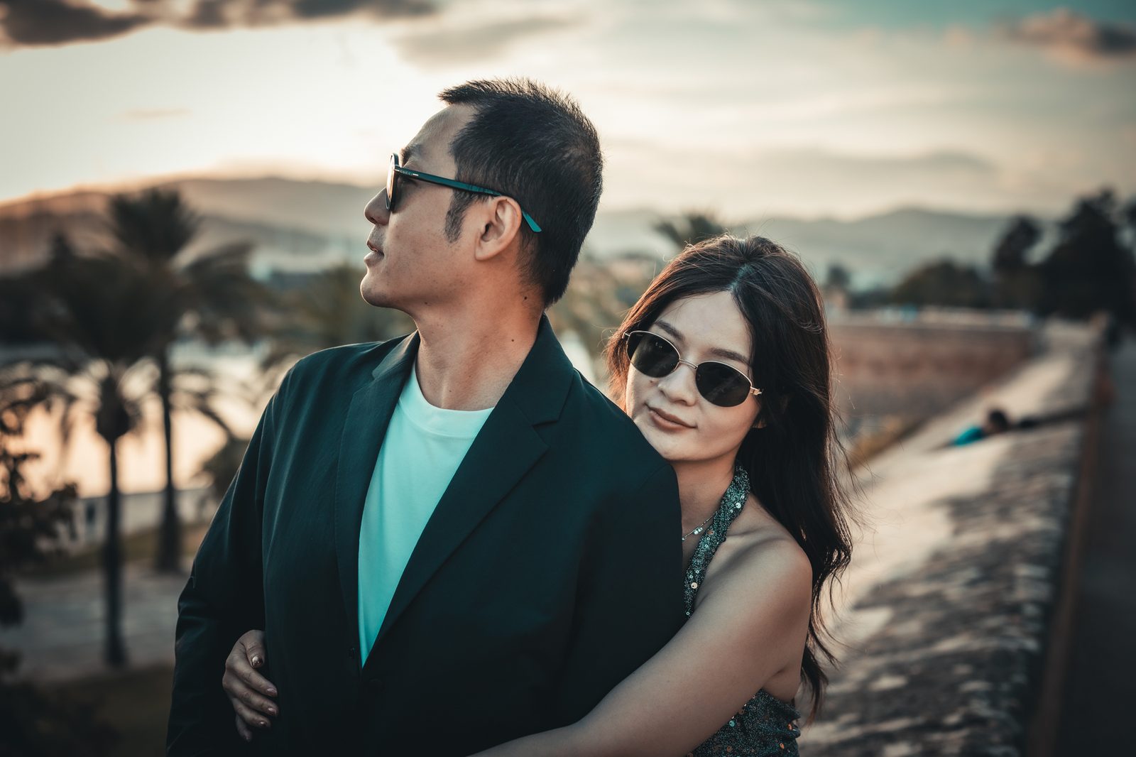Couple together in sunglasses in evening light.