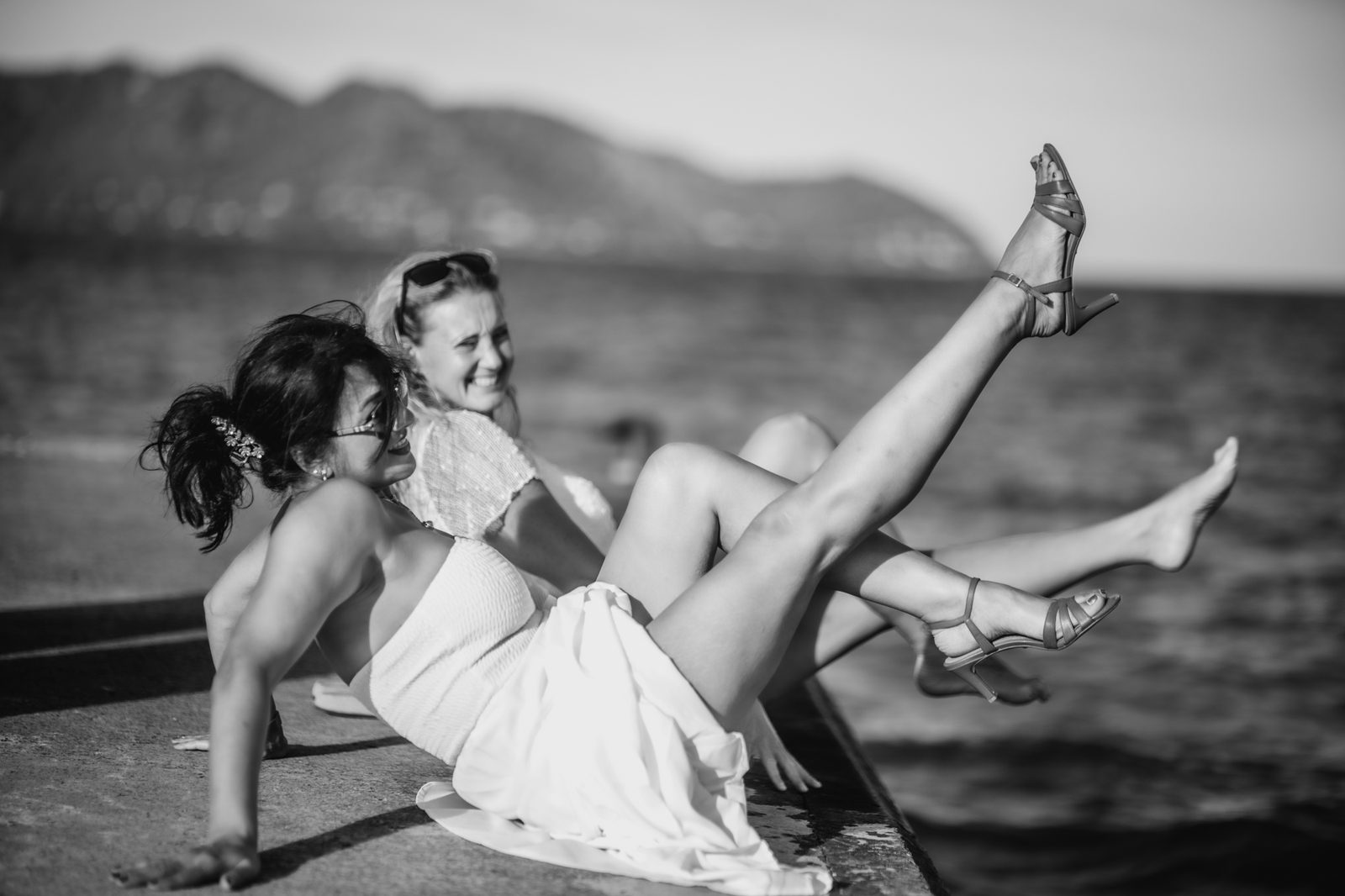 Playful black and white portrait by the sea.