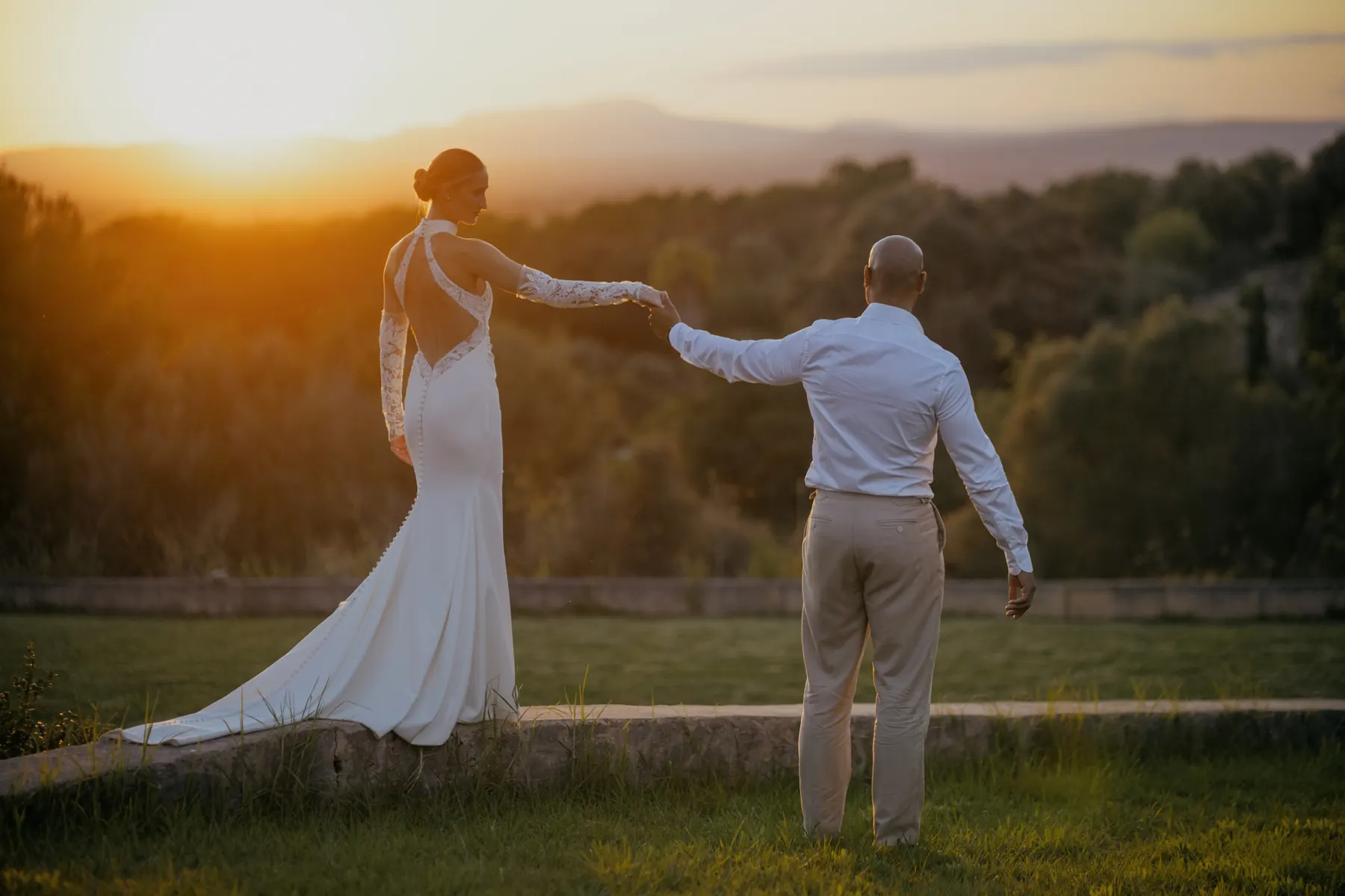 Wedding couple walking together at sunset