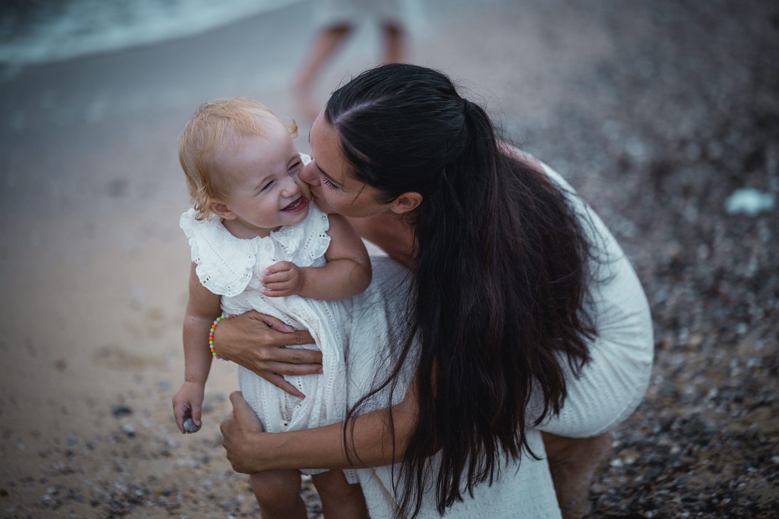 Mother holding her child closely outdoors.