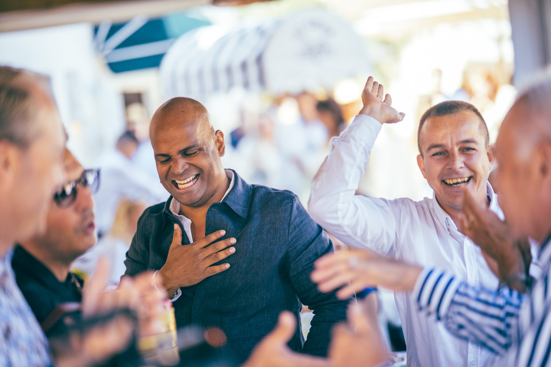 Guests laughing and cheering together at an event.