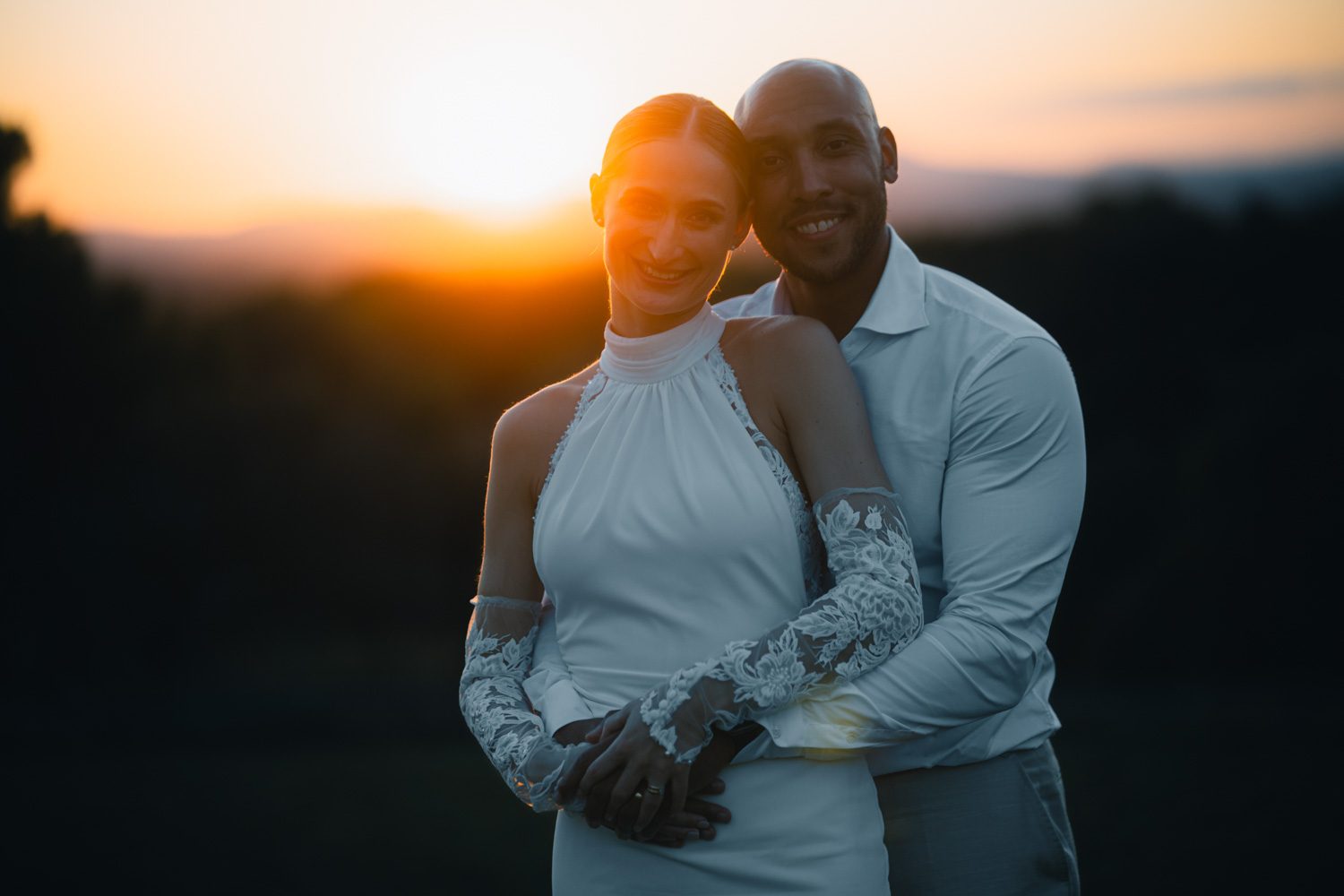 Couple holding each other at sunset.