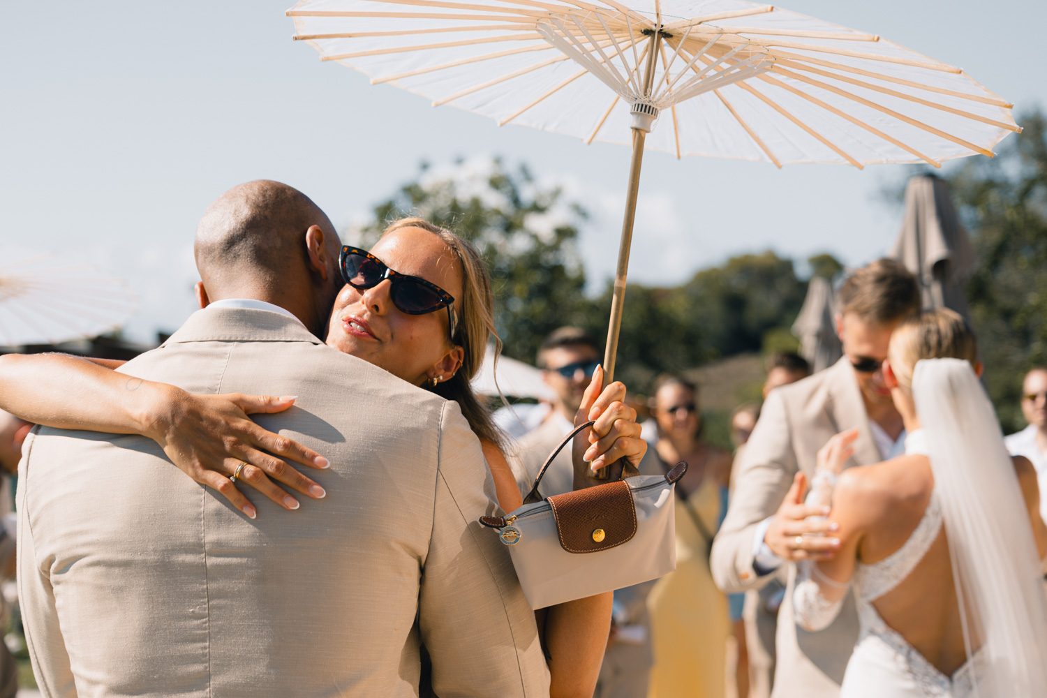 Guests and family gathered in soft daylight during the ceremony.