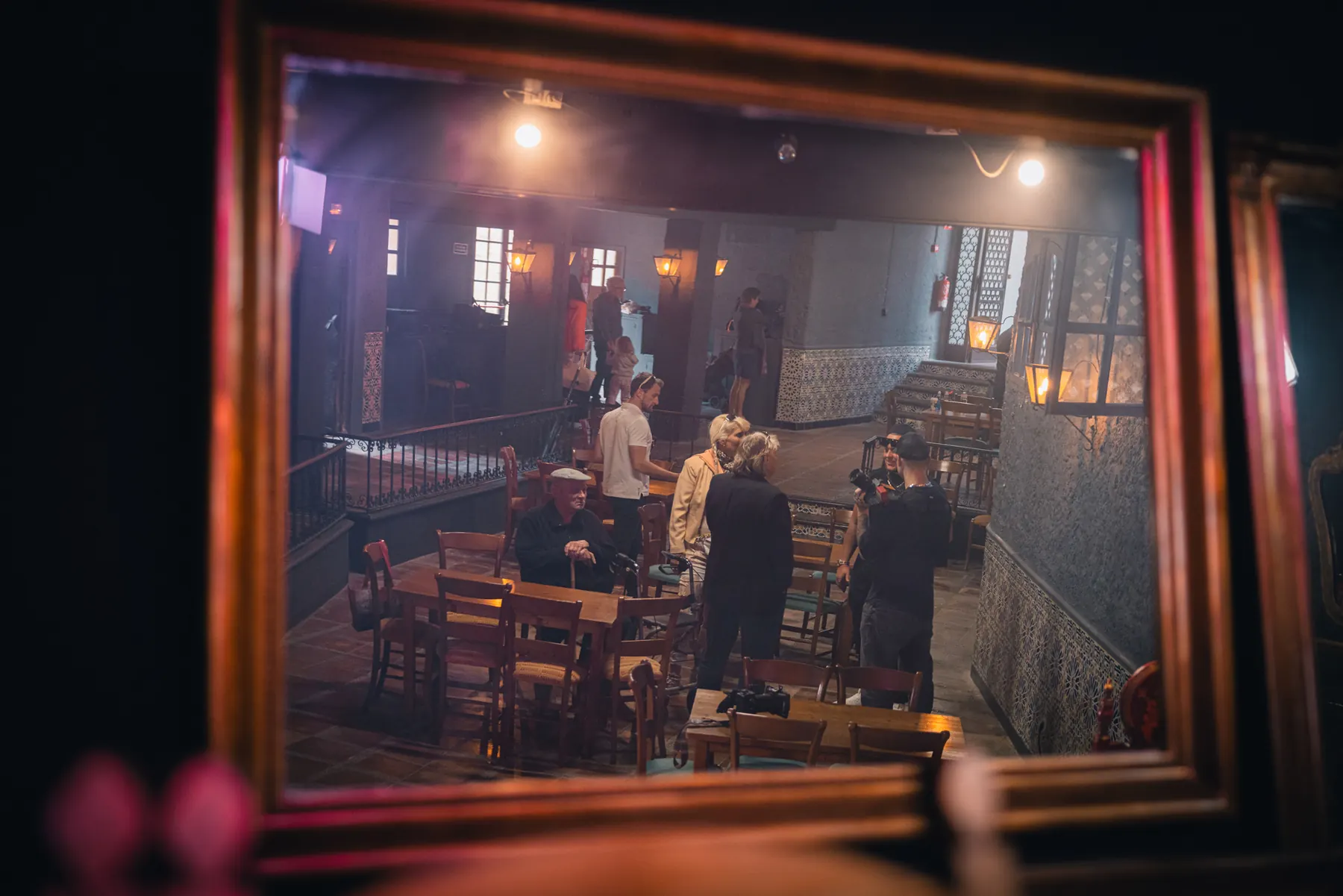 People seen through a framed interior scene
