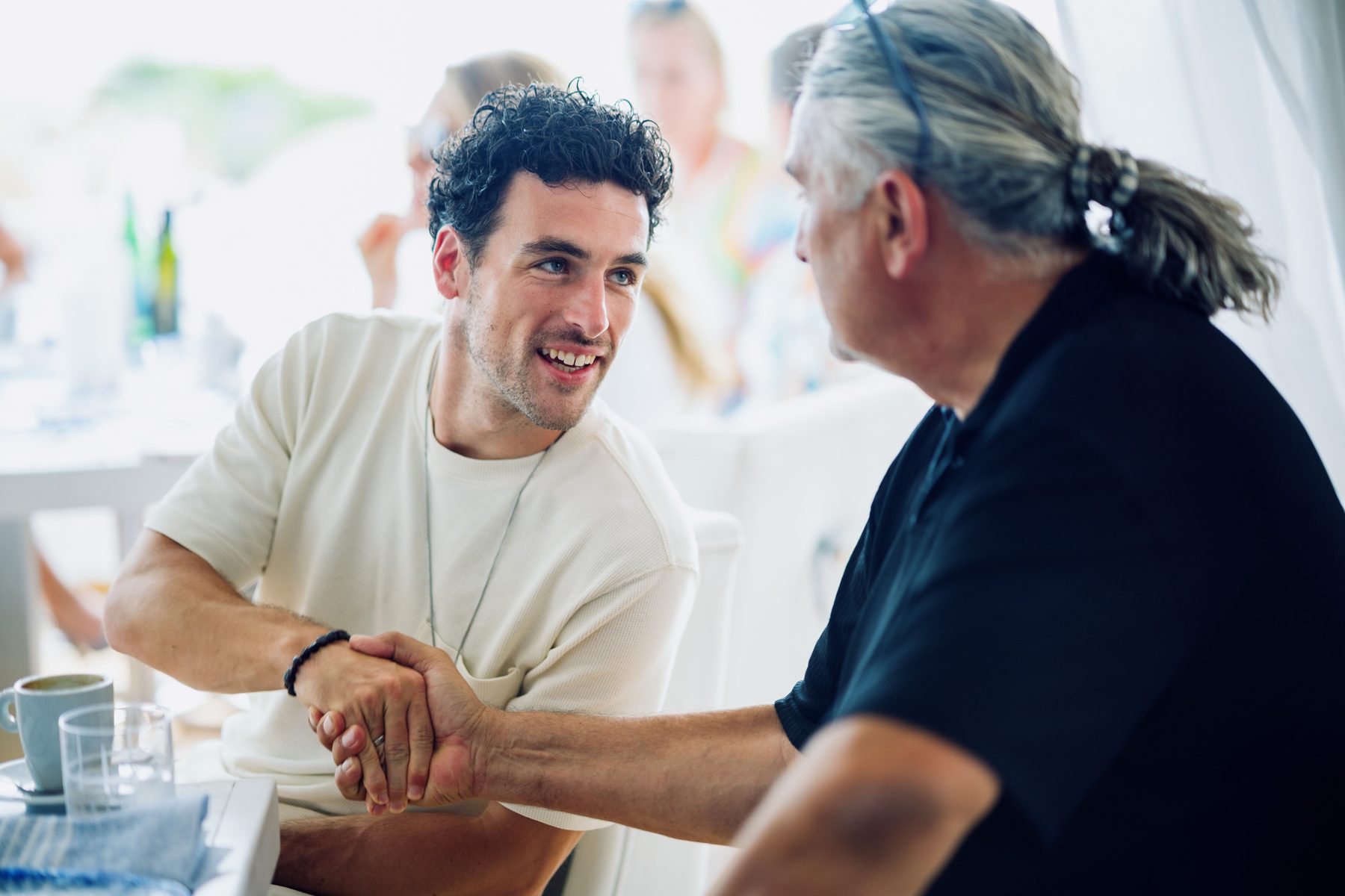 Two men greeting each other during an event.