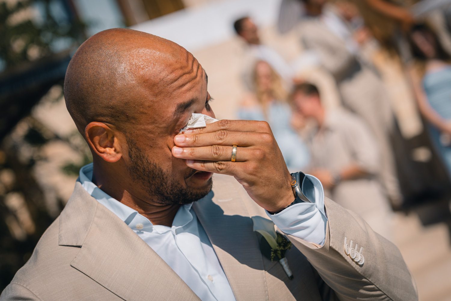 Guest wiping away tears during the ceremony.
