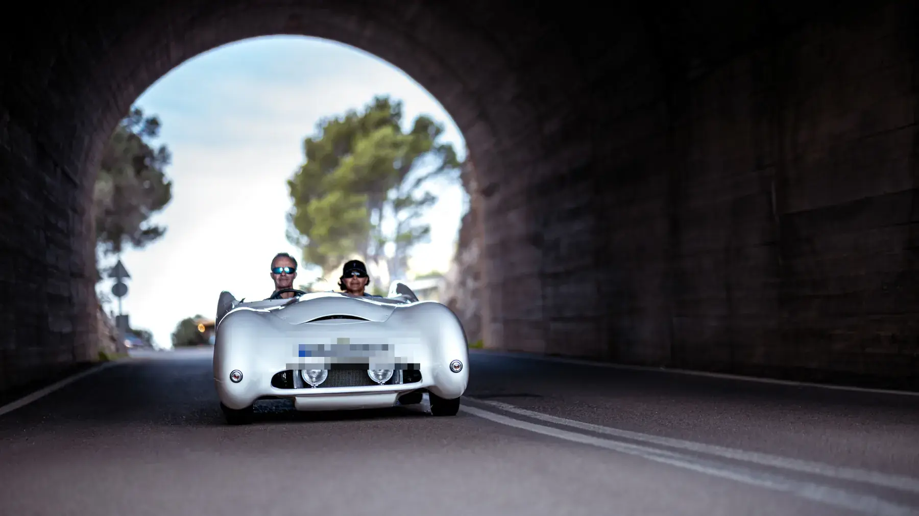 Classic car driving through a tunnel