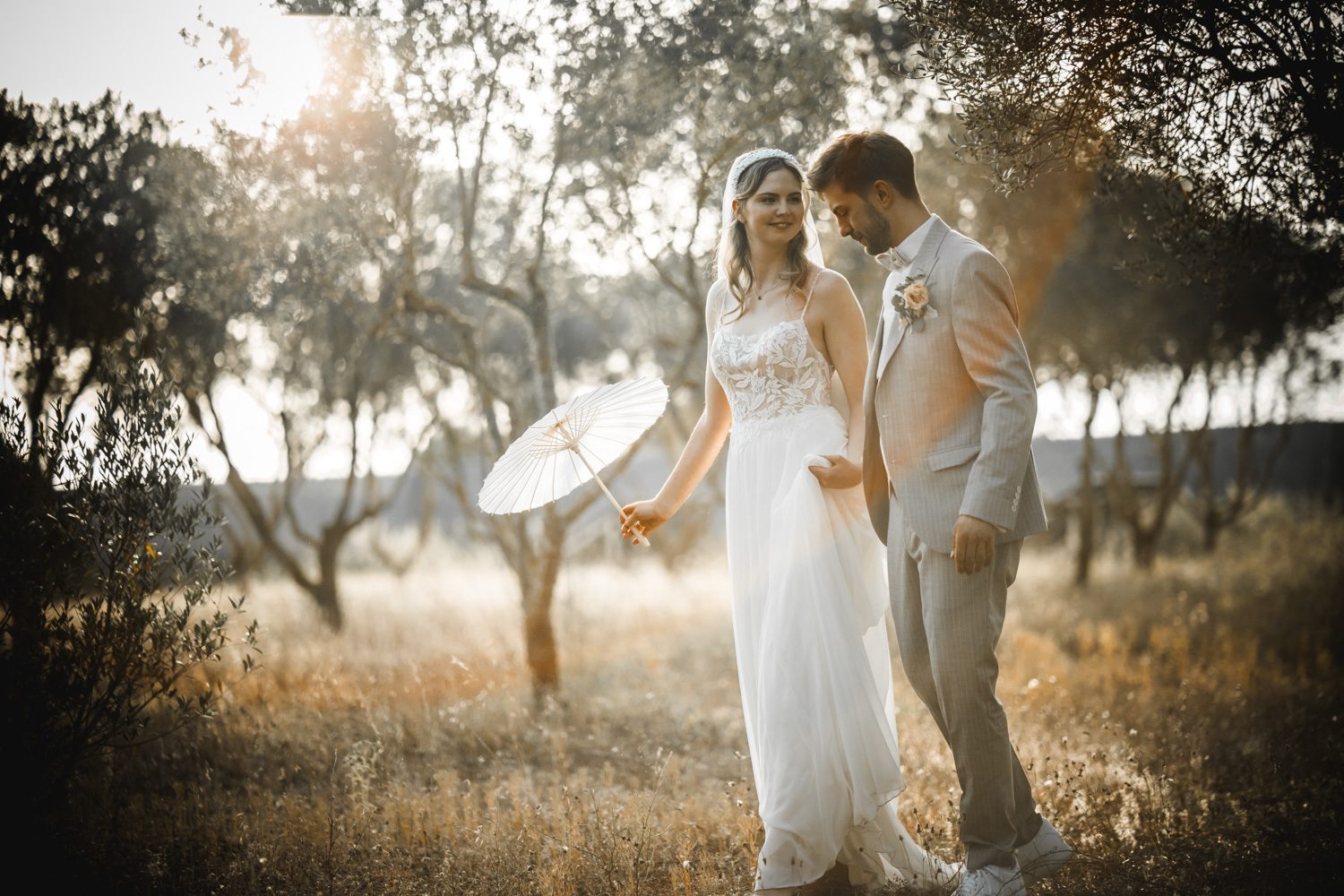 Newlyweds walking together through warm Mediterranean light.