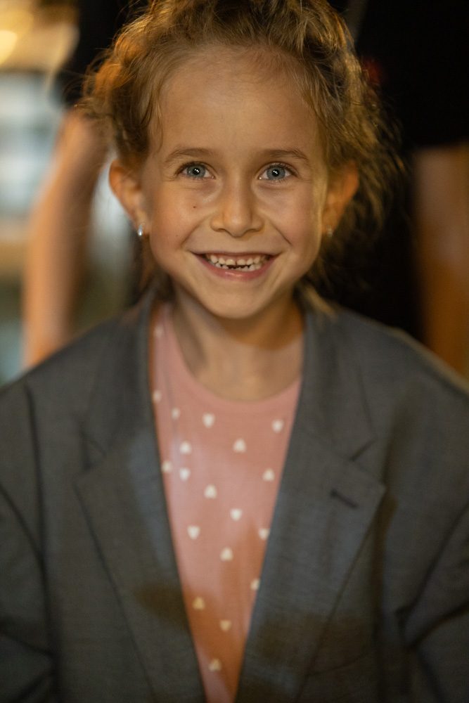 Young child smiling during the wedding day.
