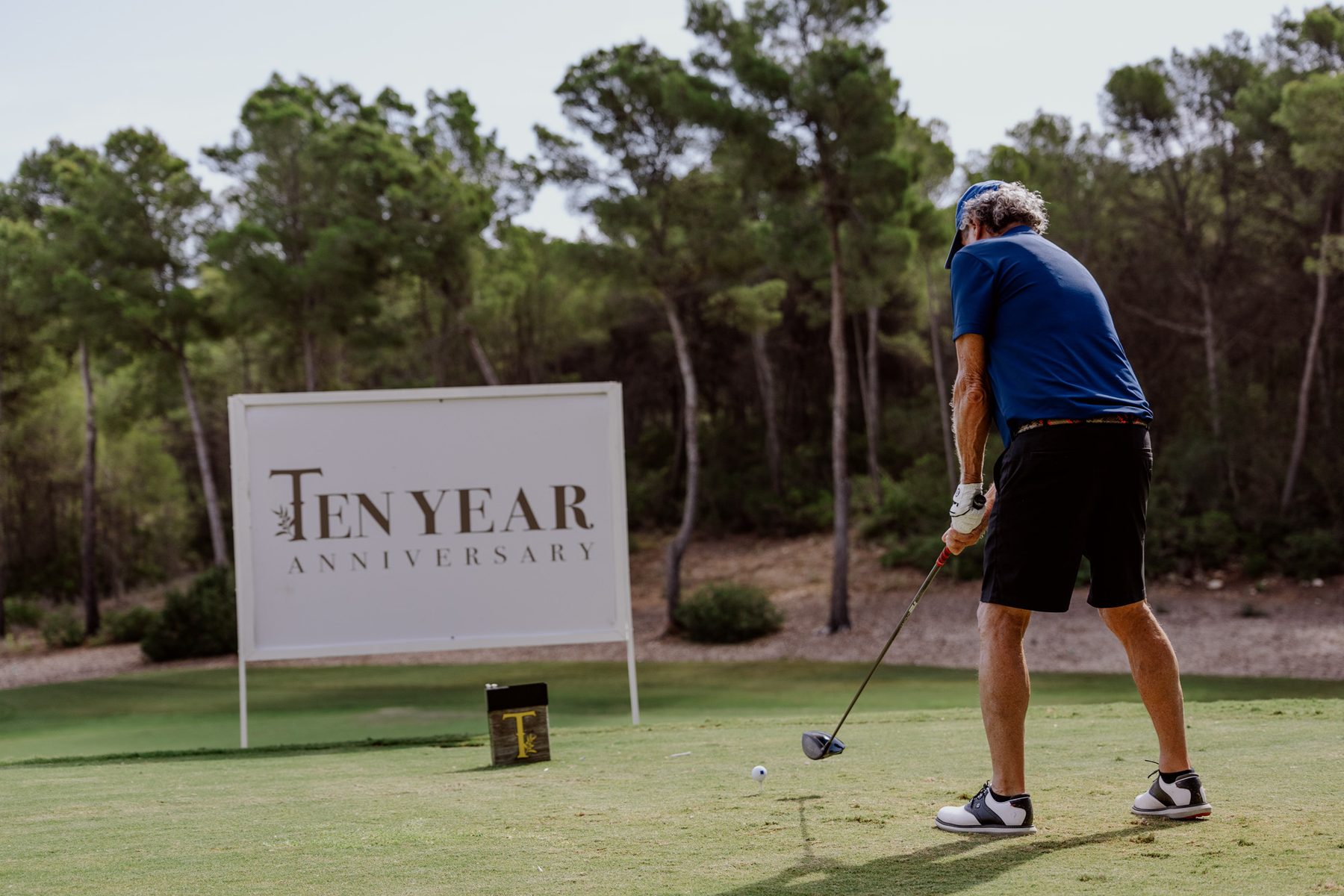 Branded anniversary sign beside a golf activity.