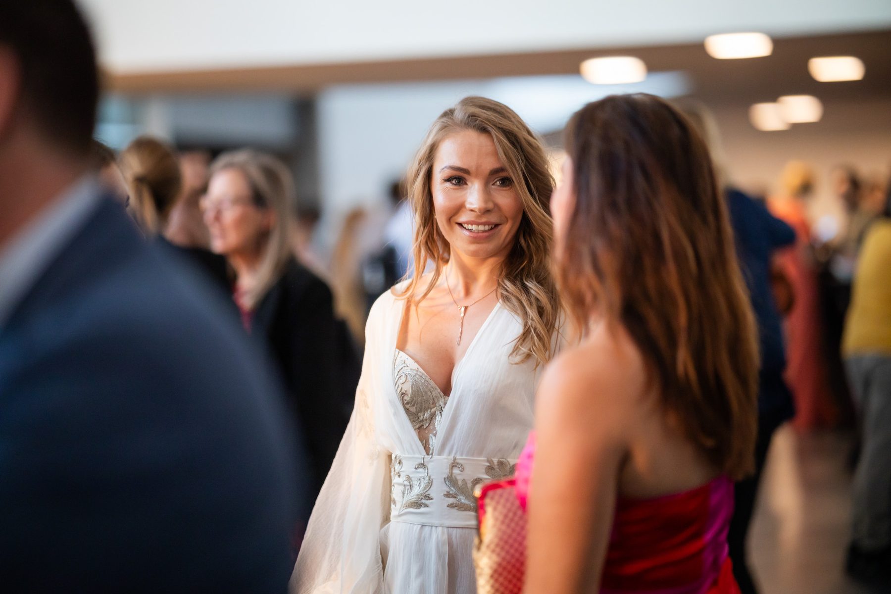 Two guests in conversation during a reception.