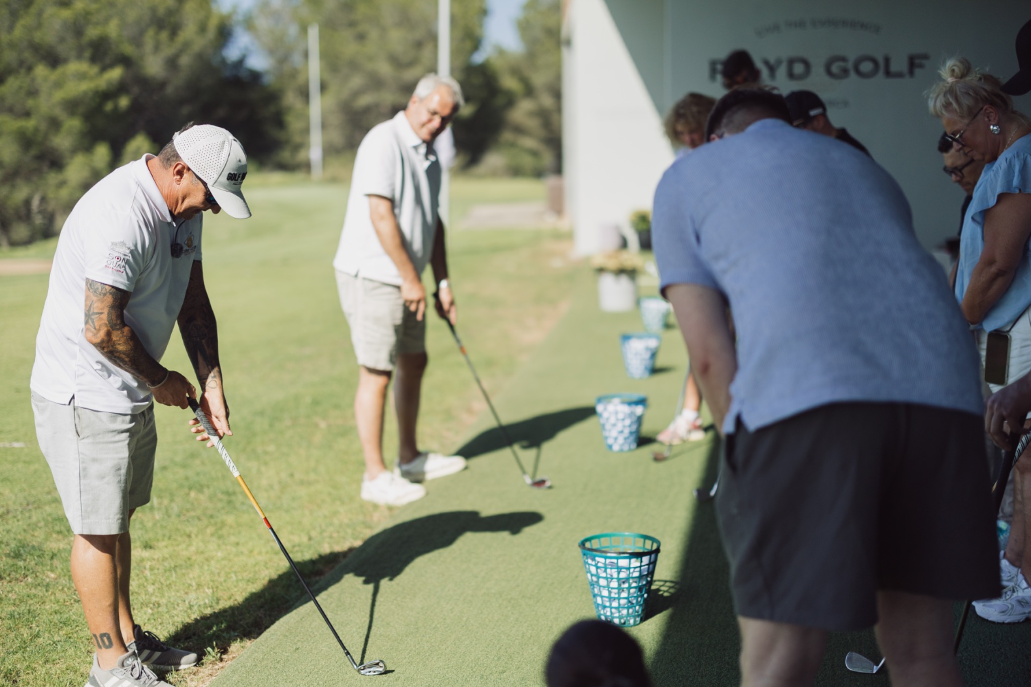 Participants practicing golf together during the team-building day