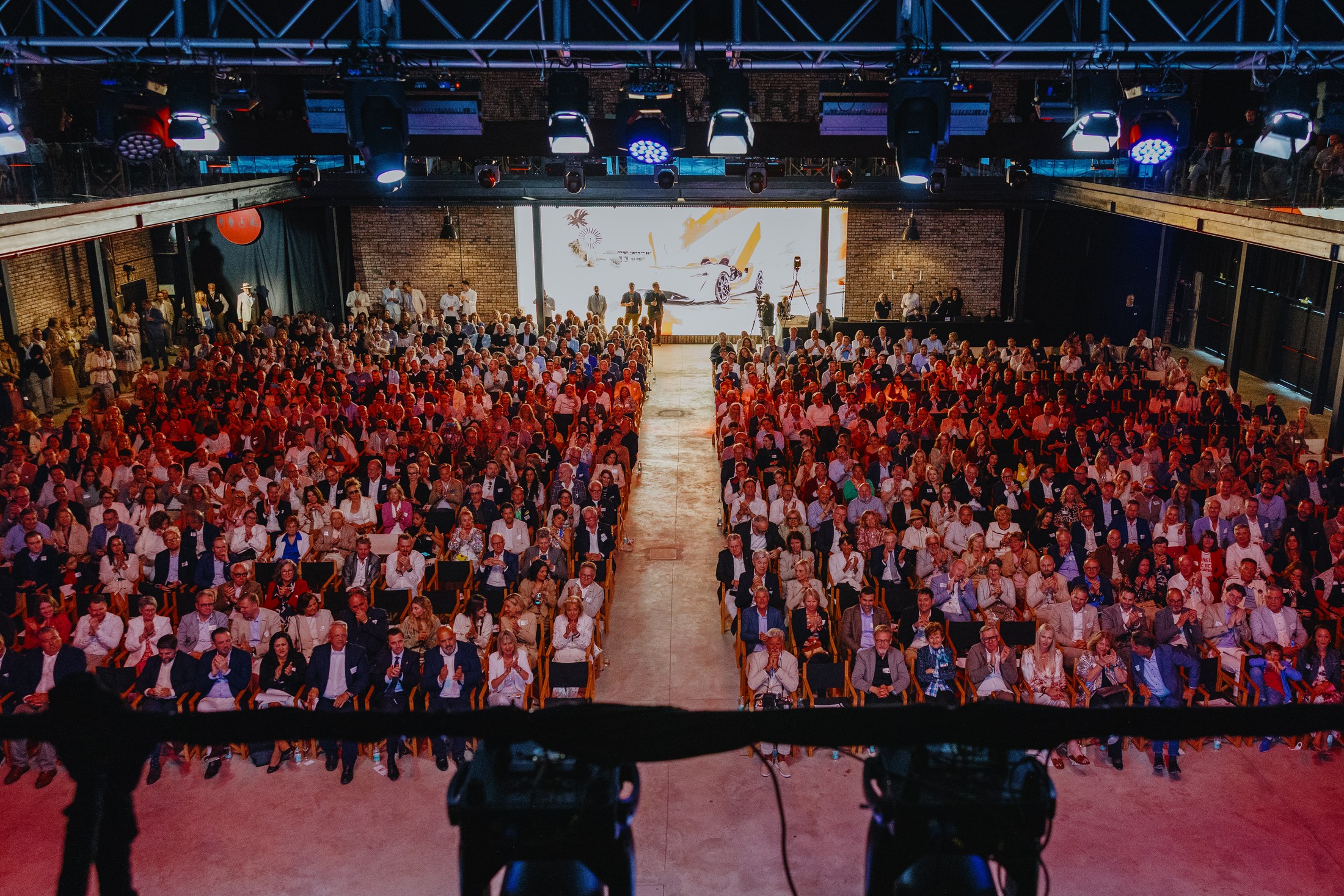 Large audience gathered for a stage programme inside Motorworld Mallorca.
