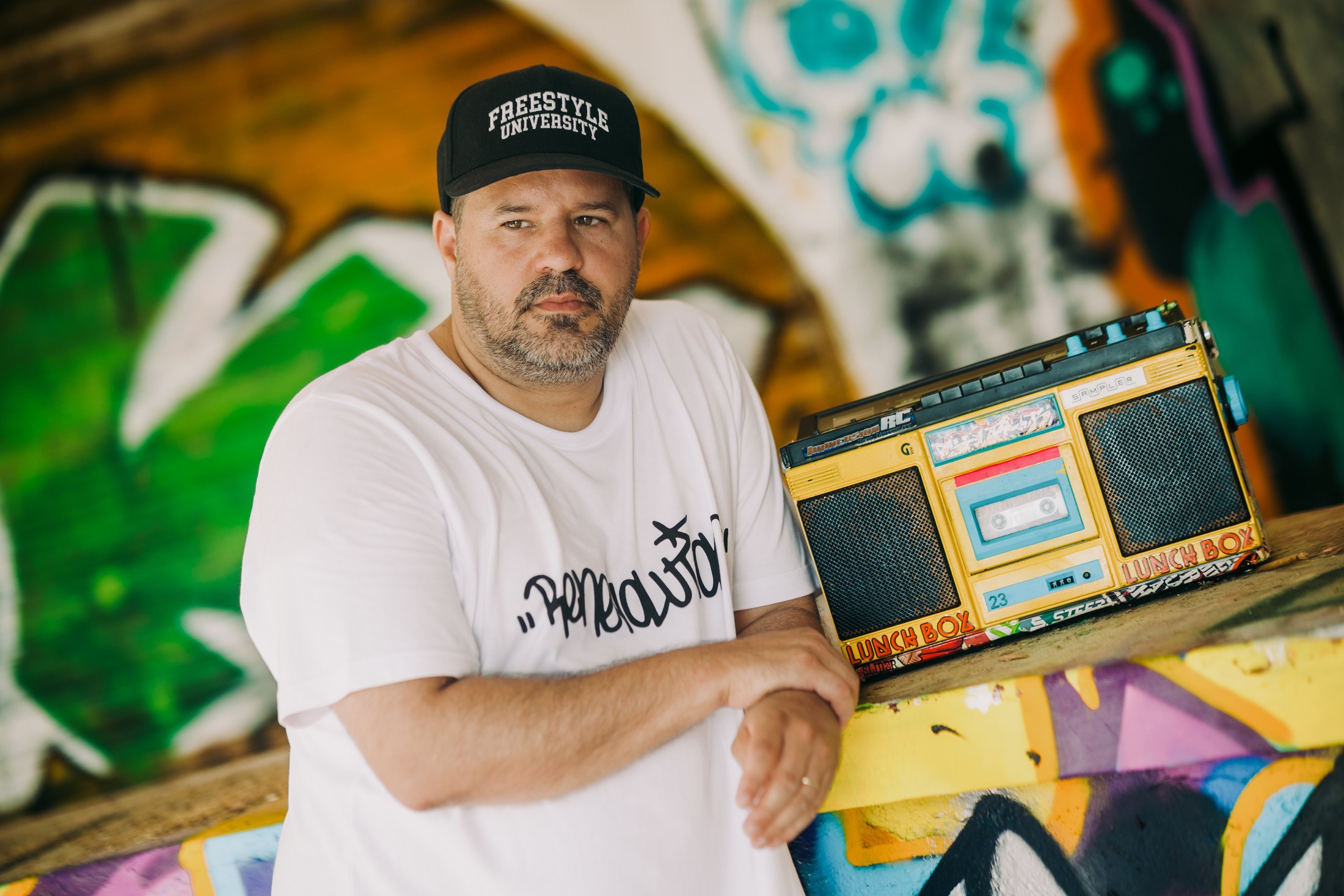 Man standing beside a vintage music machine.