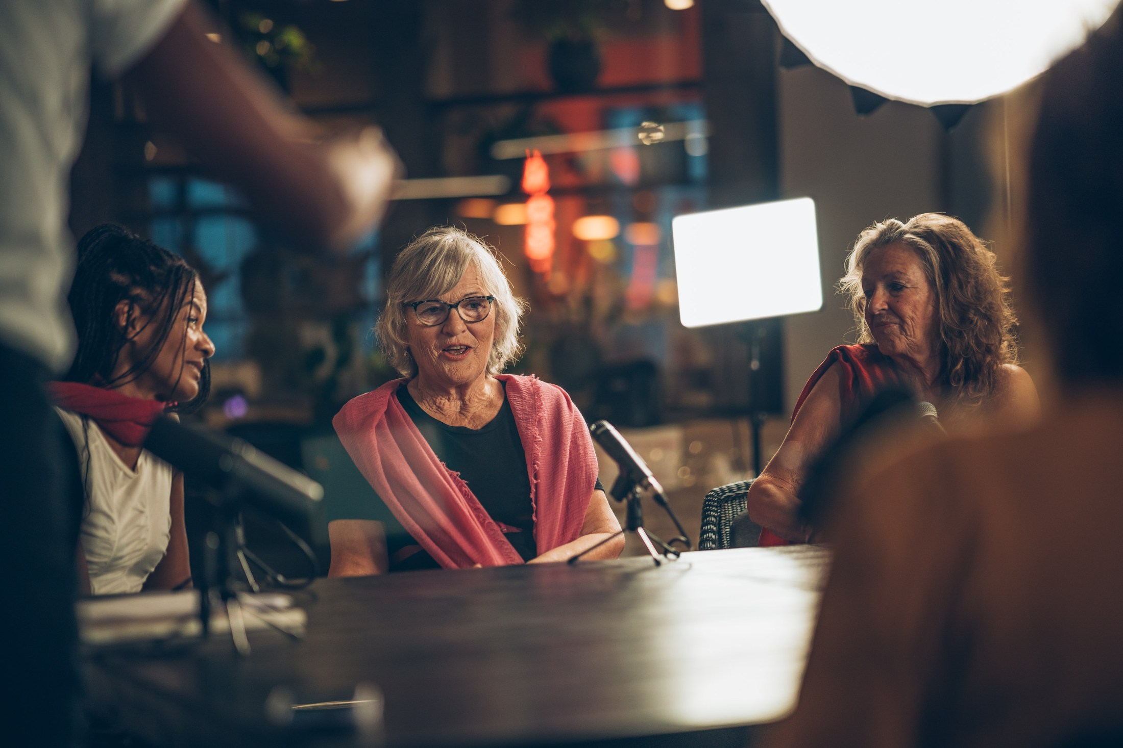 Women gathered around a table during an evening production.
