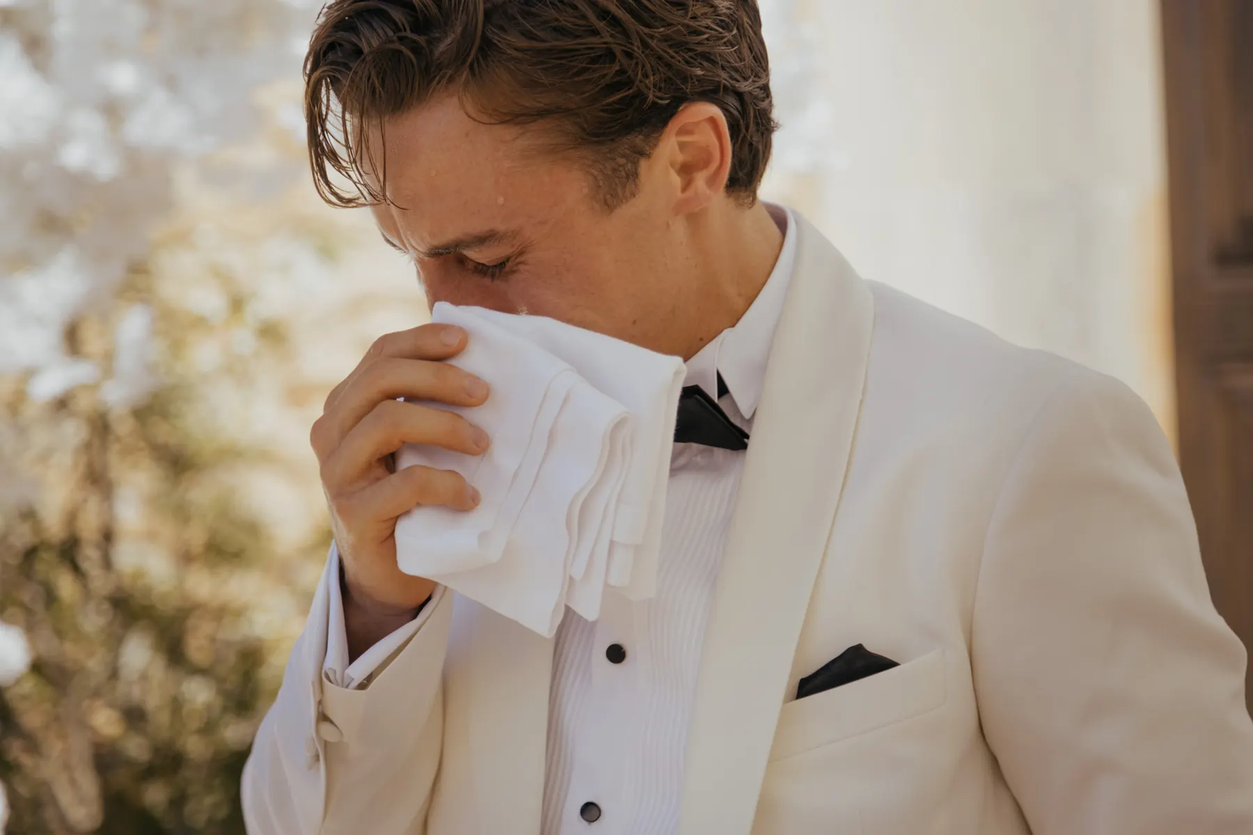 Groom holding a handkerchief during a wedding
