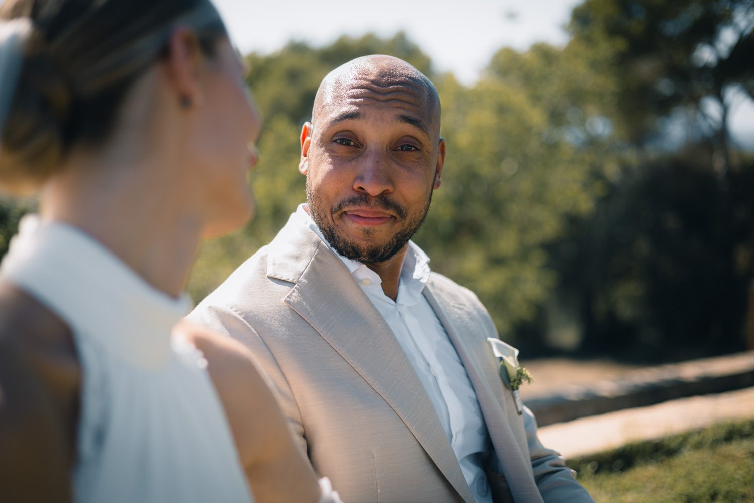 Groom looking toward the bride during the ceremony.