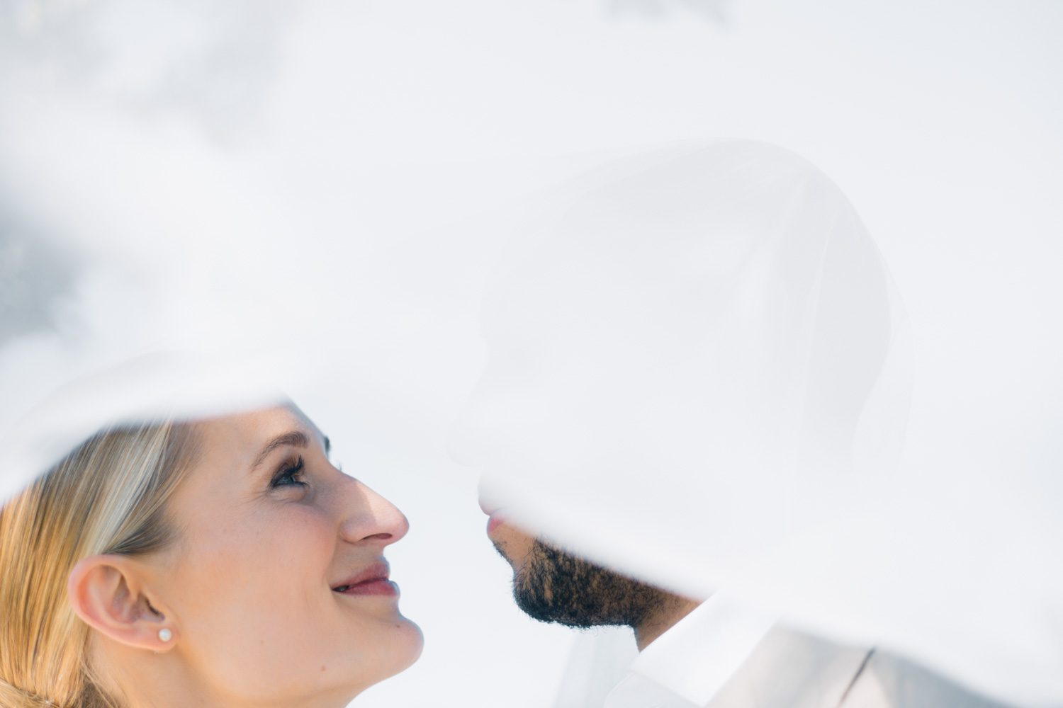 Newlyweds seen softly through the bridal veil.