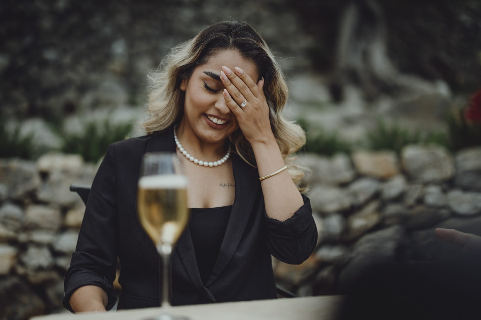 Woman laughing with her hand over her face.