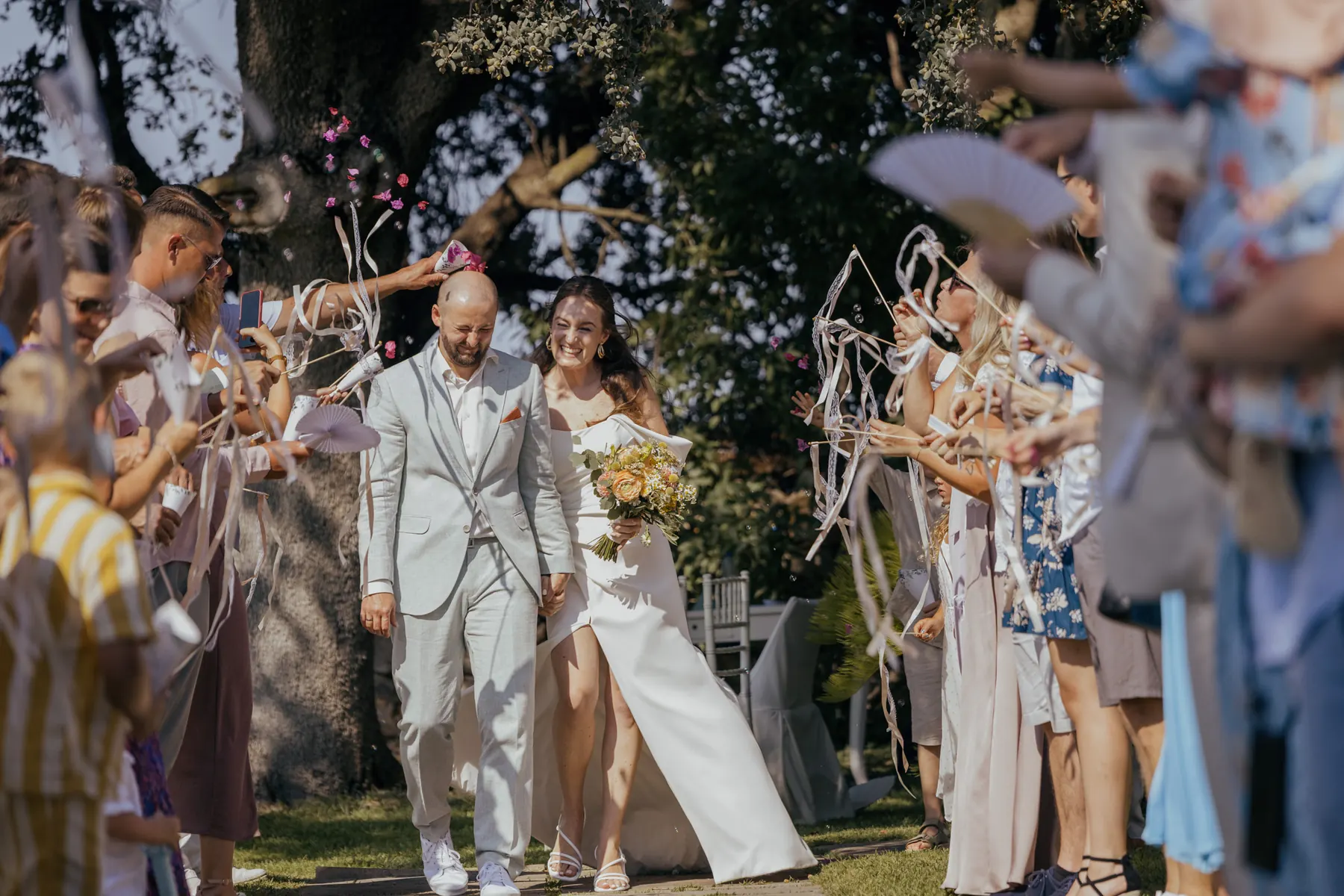 Newlyweds walking through guests after their ceremony