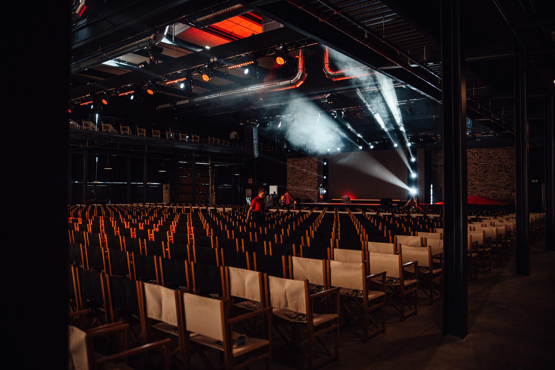 Prepared stage and rows of chairs before an event begins.