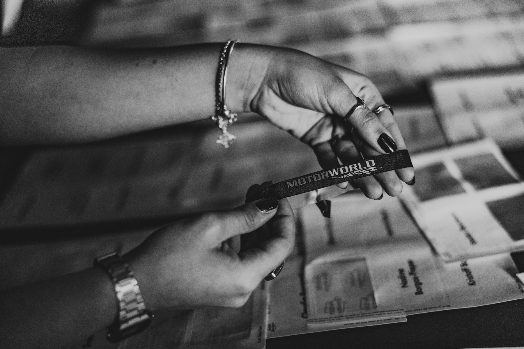 Close view of a hand preparing printed event materials.