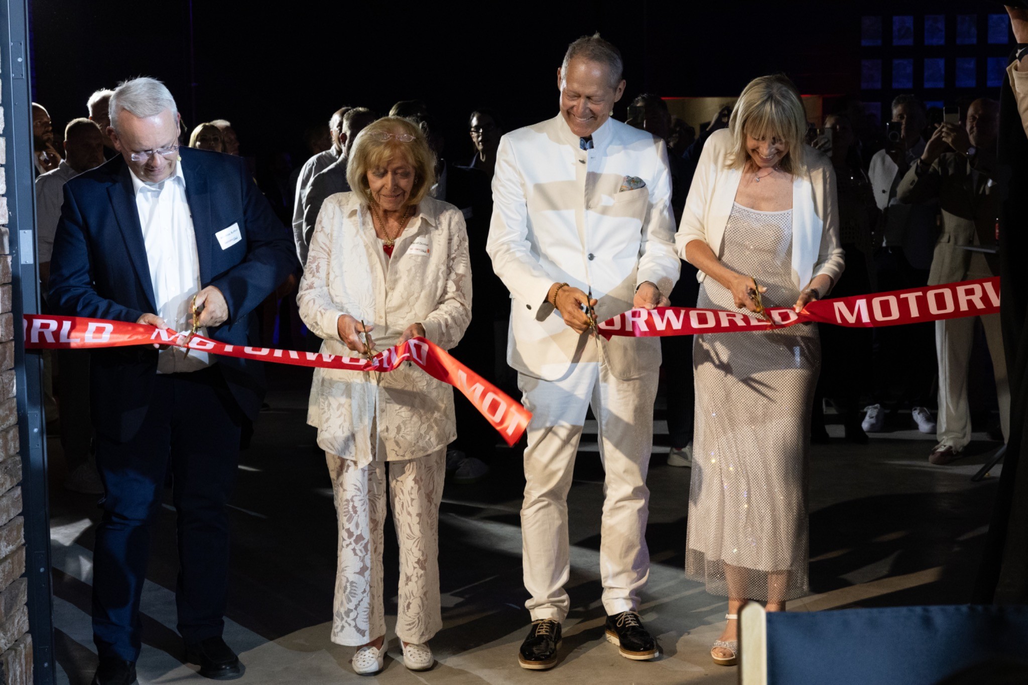 Classic car detail with guests in conversation during the Motorworld Mallorca opening