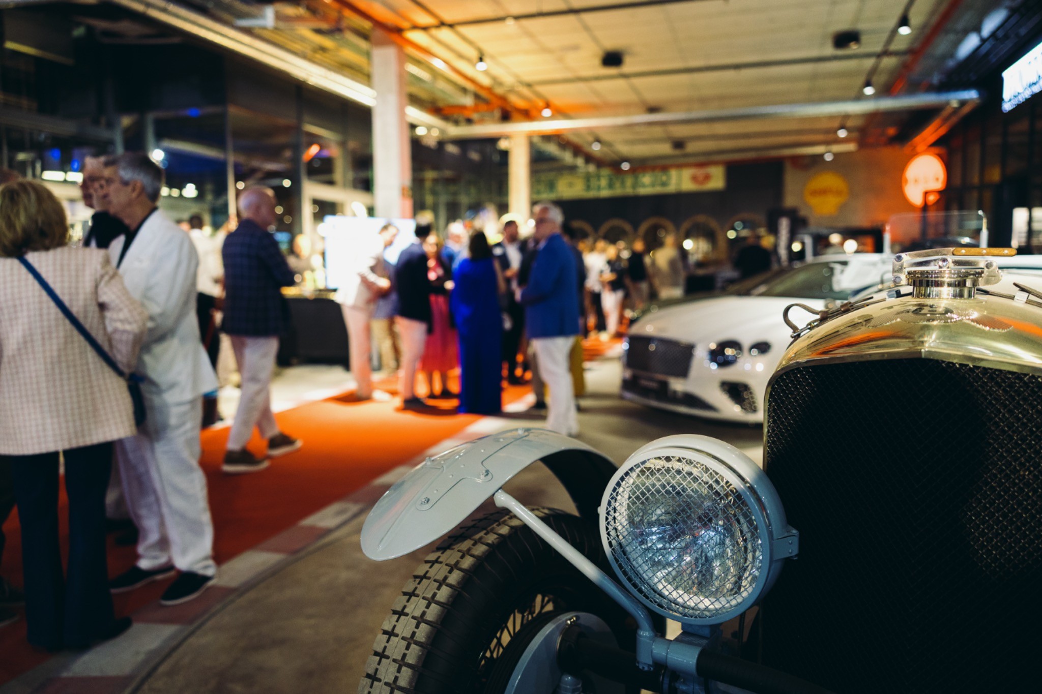 Mercedes car detail with guests in the background during the opening event