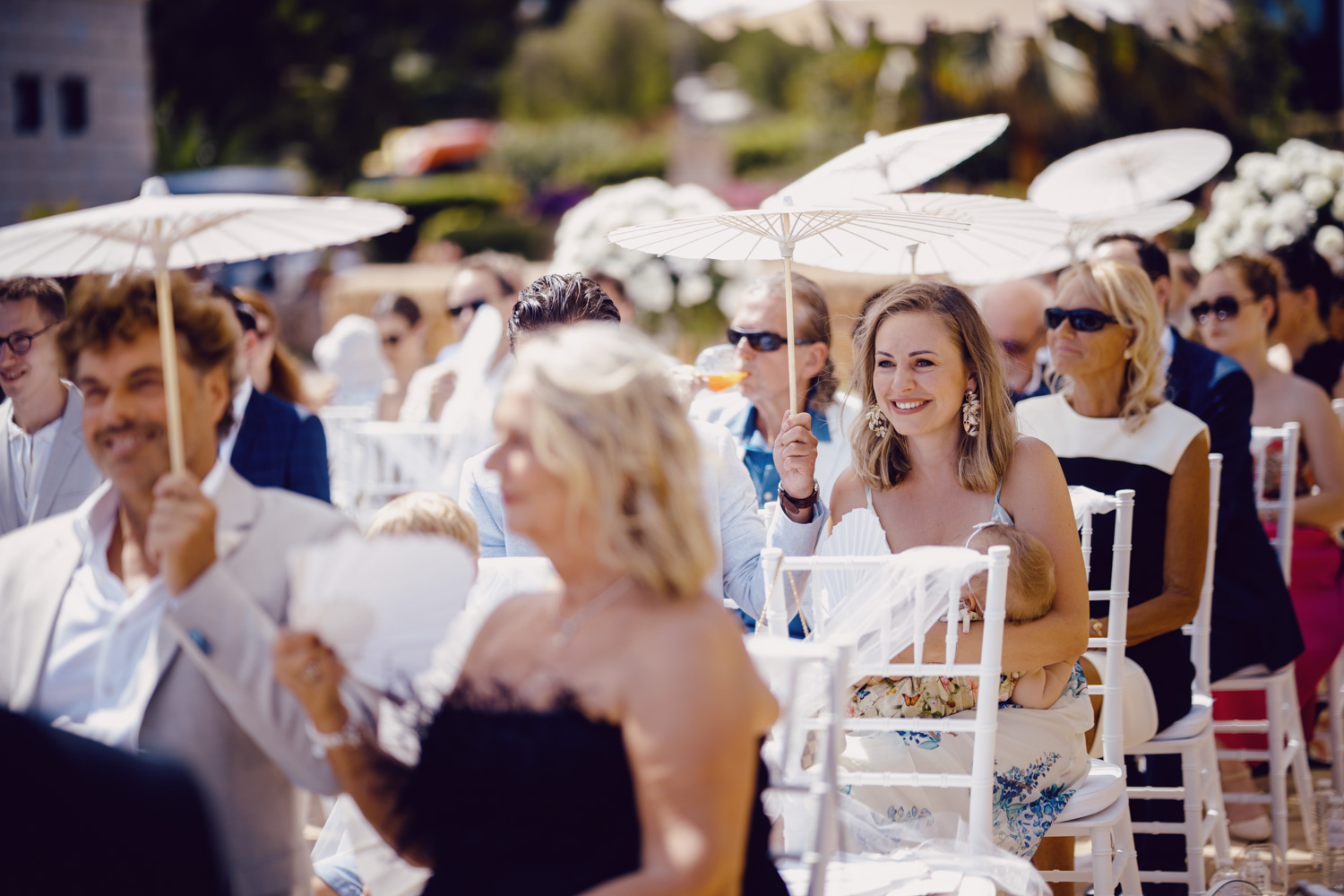 Guests reacting during an outdoor ceremony.