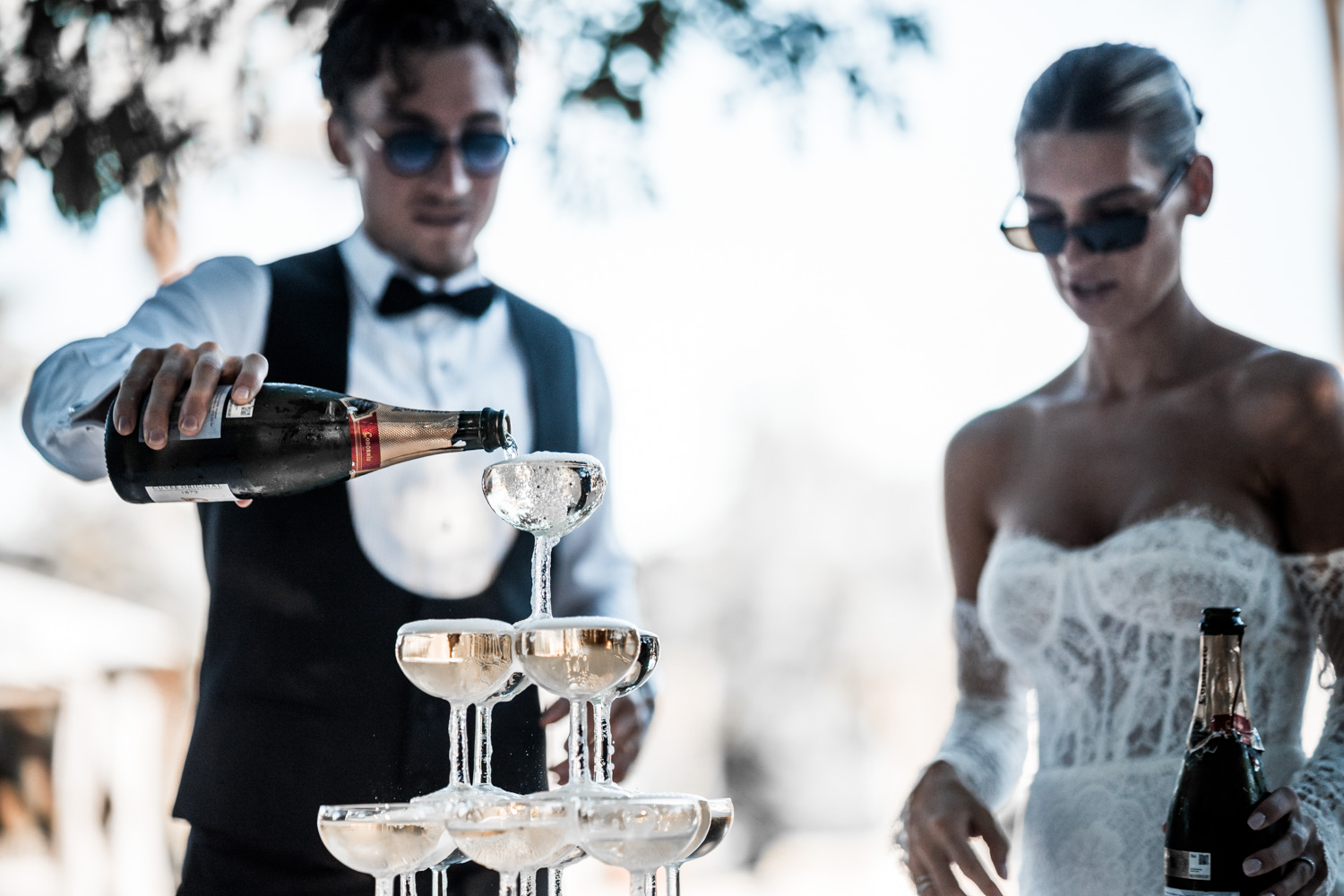 Bride and groom sharing champagne during a reception moment.