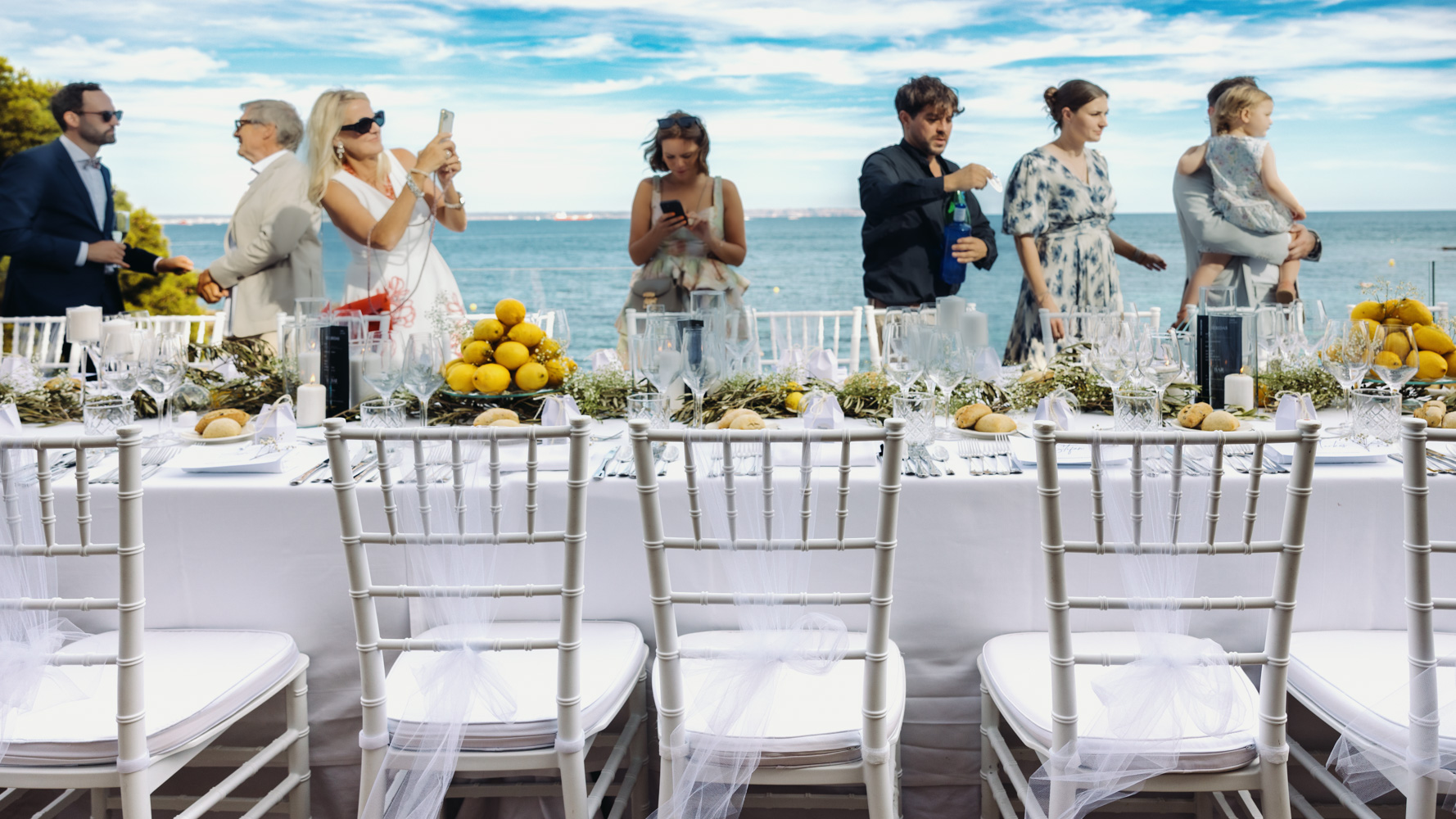 A long wedding table overlooking the Mediterranean.