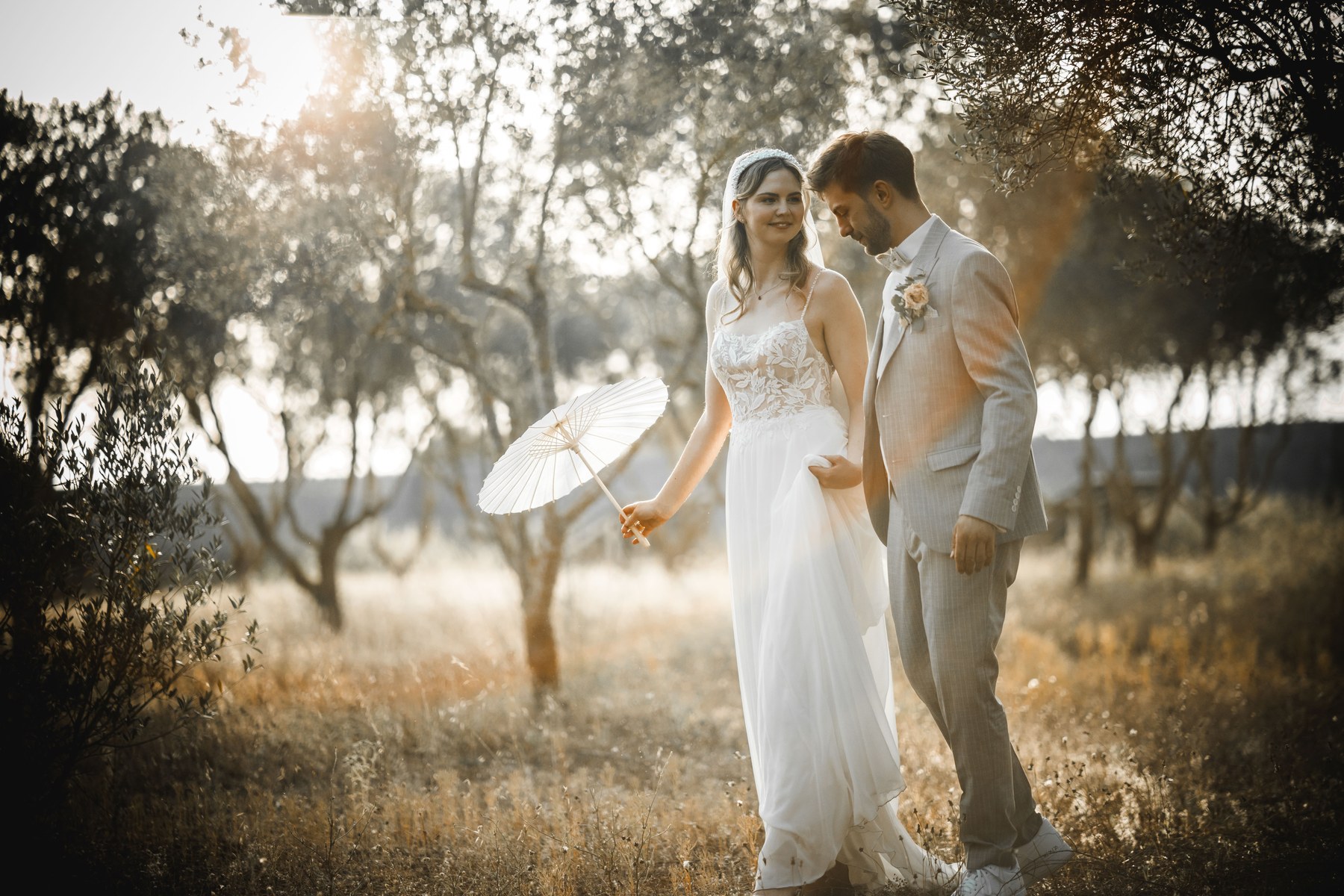 Annarina and Basti walking together in warm evening light.