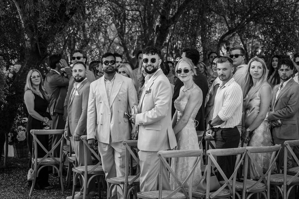Guests gathered beneath the trees during the ceremony.