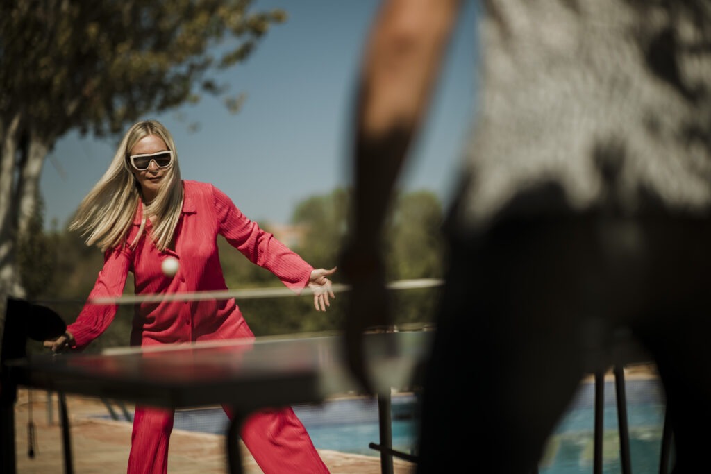 woman in a red dress playing ping pong